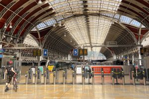 London, England - June 2022: Deserted platform at the ticket barriers on the concourse of Paddington railway station on the day of strike action on the rail network